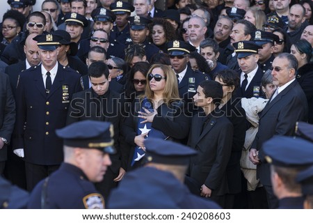 NEW YORK, NY - DECEMBER 27, 2014: Maritza Ramos, Justin Ramos and Jared Ramos hold colors at  Christ Tabernacle Church for the funeral of slain New York City Police Officer Rafael Ramos