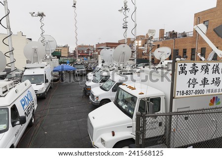 Brooklyn, NY - January 04, 2015: Media trucks stationed outside of Aievoli Funeral Home for the funeral of slain New York City Police Officer Wenjian Liu
