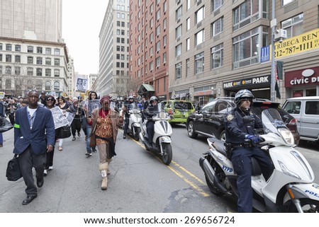 New York, NY - April 14, 2015: Protesters against police brutality walk down around Foley Square