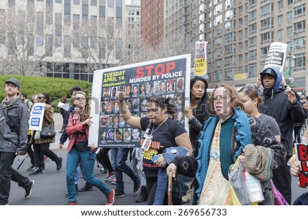 New York, NY - April 14, 2015: Protesters against police brutality walk down around Foley Square