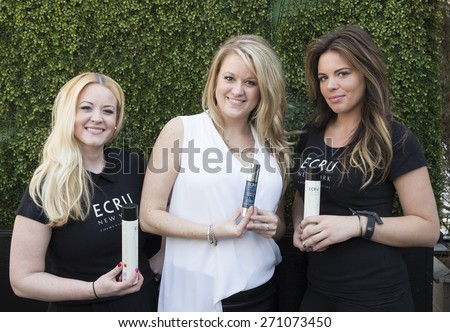 New York, NY - April 18, 2015: Director of ECRU Heather Roetman (C) and sales girls shows cosmetics by ECRU backstage for Malan Breton bridal collection at Empire Hotel Rooftop lounge