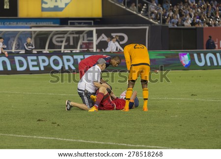 New York, NY - May 15, 2015: Jeff Larentowicz of Chicago Fire laying on the field receives treatment during the game between New York City Football Club and Chicago Fire FC at Yankee Stadium