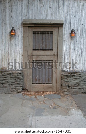 Nailed door with two lanterns in meatpacking district in Manhattan New York