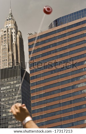 yo-yo against background with skies and New York buildings