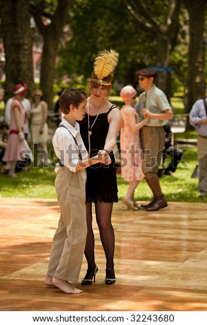 NEW YORK - JUNE 6: Mother and son in period clothing dance at 5th Annual Jazz age concert and picnic on Governors Island on June 6 2009 in New York