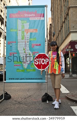 NEW YORK - AUGUST 8:  An unidentified crossing guard with stop sign during first day of summer streets festival on 4th avenue August 8, 2009 in Manhattan, New York.
