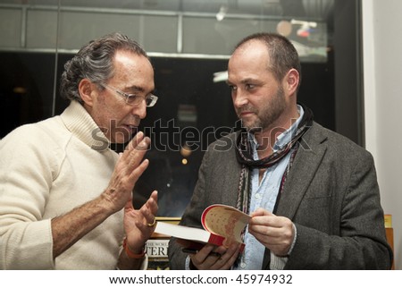 NEW YORK - FEBRUARY 04: Colum McCann (R) signs his book Let the Great World Spin for unidentified man at McNally Jackson bookstore A Celebration of GRANTA magazine on February 04, 2010 in New York City.