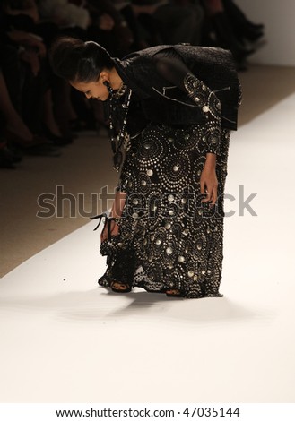 NEW YORK - FEBRUARY 18: Model slips on the runway for Naeem Khan Collection at Fall 2010 during Mercedes-Benz Fashion Week on February 18, 2010 in New York