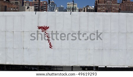 red paint on white billboard
