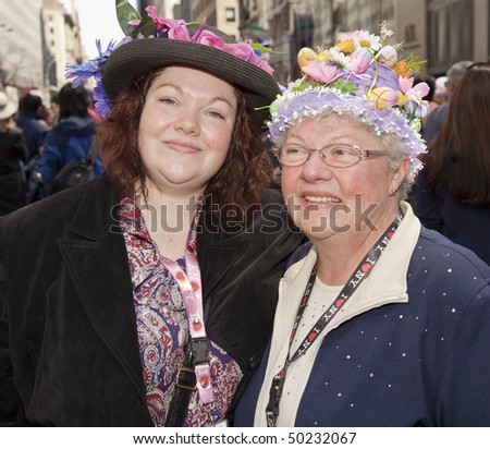 NEW YORK - APRIL 4: Mother and daughter partake and show off their hats in the Easter Bonnet Parade on 5th Avenue on April 4, 2010 in New York City.