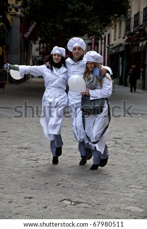 MADRID - NOVEMBER 25: Young cooks dance on the street next to Plaza Mayor to promote Kraft Philadelphia cream cheese in Madrid, Spain on November 25, 2010