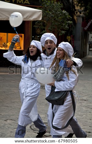 MADRID - NOVEMBER 25: Young cooks dance on the street next to Plaza Mayor to promote Kraft Philadelphia cream cheese in Madrid, Spain on November 25, 2010