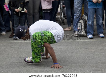 NEW YORK - APRIL 30: Member of break dancers \'Two Steps Away\' performs at the Family Festival Street Fair during the 2011 Tribeca Film Festival on Greenwich Street on April 30, 2011 in New York City