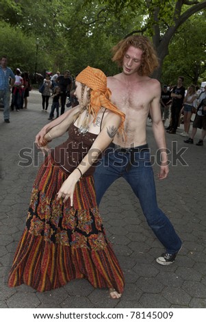 NEW YORK - MAY 21: Unidentified couple dances in Tompkins Square park as part of New York Dance Parade on May 21, 2011 in New York City