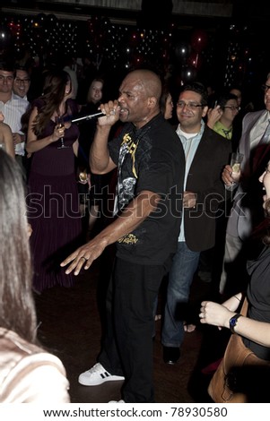 NEW YORK - JUNE 08: Darryl \'DMC\' McDaniels of Run-DMC performs on floor among guests with a guest at the 2011 Urban Arts Partnership Prom Party at The Edison Ballroom on June 8, 2011 in New York City