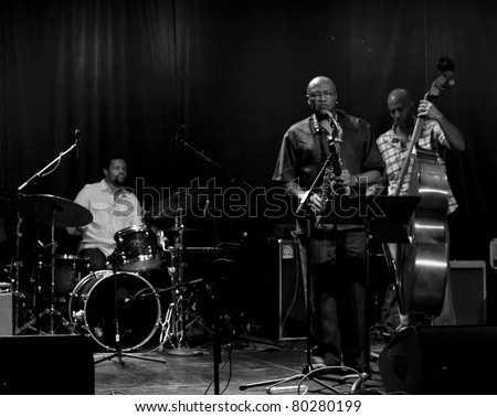 NEW YORK - JUNE 23: Band Tarbaby Nasheem Waits drums, Oliver Lake alt sax, Eric Revis bass performs at Le Poisson Rouge as part of annual Undead Jazz Festival on June 23, 2011 in New York City.