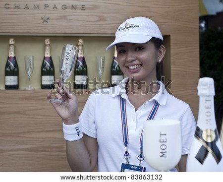 NEW YORK - SEPTEMBER 01: A server holds a glass at the food court with Moet & Chandon Champagne at US Open at USTA Billie Jean King National Tennis Center on September 01, 2011 in New York City.