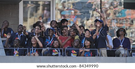 NEW YORK - SEPTEMBER 09: First Lady Michelle Obama & daughter Sacha attend the 2011 US Open at USTA Billie Jean King National Tennis Center on September 9, 2011 in New York City.