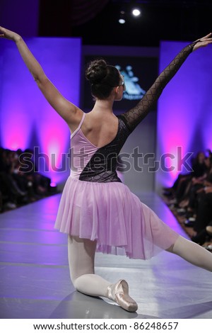 NEW YORK - SEPTEMBER 17: Members of Nika Ballet Company perform on runway for collection by Andres Aquino of USA at Couture Fashion Week in Waldorf Astoria on September 17, 2011 in New York City