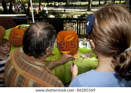 NEW YORK - OCTOBER 09: Hugh McMahon demonstrates the art of pumpkin carvings to visitors in preparation for Halloween in Central park on October 09, 2011 in New York City