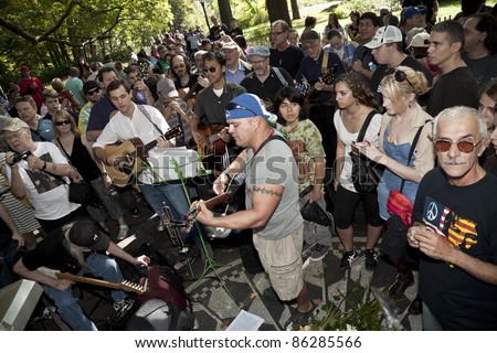 NEW YORK - OCTOBER 09: Crowd celebrates legacy of John Lennon on his birthday and Beatles at Strawberry Field in Central park on October 09, 2011 in New York City