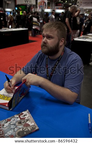 NEW YORK - OCTOBER 13: Robert Kirkman author of The Walking Dead signs book during New York Comic Con 2011 in Javits Center on October 13, 2011 in New York.