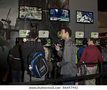 NEW YORK - OCTOBER 15: Unidentified participants try new games for Xbox 360 console New York Comic Con 2011 in Javits Center on October 15, 2011 in New York.