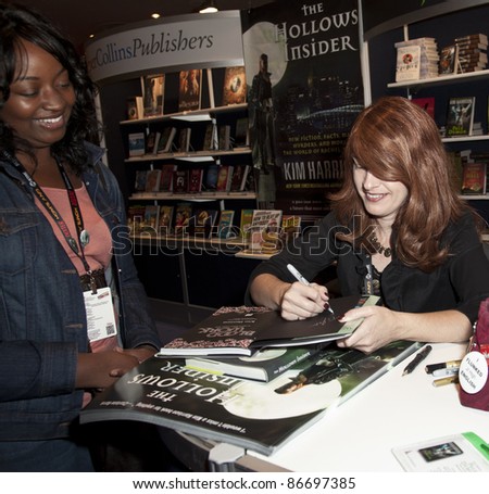 NEW YORK - OCTOBER 15: Author Kim Harrison signs book during New York Comic Con 2011 in Javits Center on October 15, 2011 in New York.