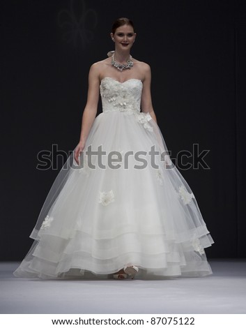 NEW YORK - OCTOBER 16: Model walks runway for Anne Barge bridal collection at New York International Bridal Week at 94 Pier on October 16, 2011 in New York City