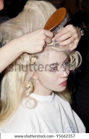 NEW YORK - FEBRUARY 14: Model prepares backstage for Malan Breton collection Mermaid during Fashion week at Metropolitan Pavilion in Manhattan on February 14, 2012 in New York City.