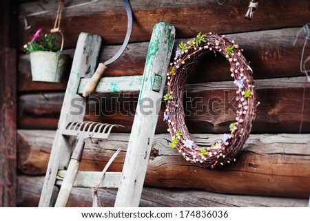 Garden tools near the wooden wall, idea for decoration