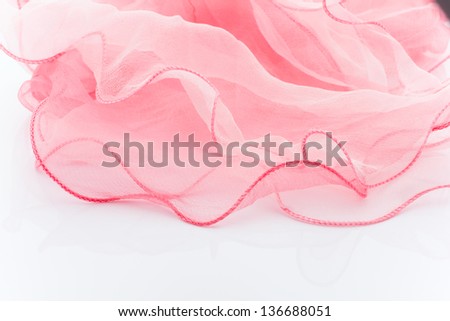 Pink silk scarf isolated on the white background.