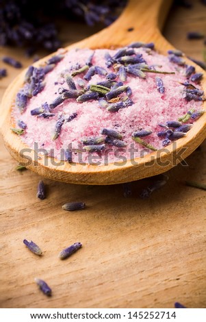 Wooden spoon with lavender sea salt. Dried lavender flowers.