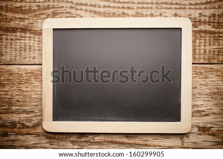 Menu blackboard and wooden background.