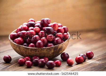 Cranberries In Wooden Bowl On Wooden Background.