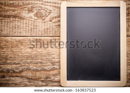 Menu blackboard and wooden background.