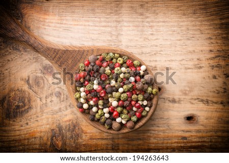 Spice mix a wooden spoon on a wooden background.