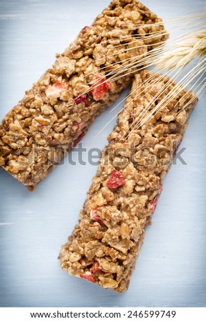 Muesli bars, cereal bars on the wooden background.