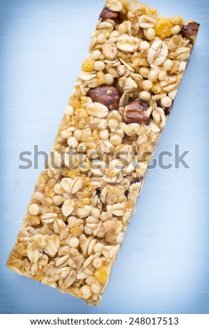 Muesli bars, cereal bars on the wooden background.