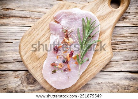 Pork chop, meat slices  on a wood background.