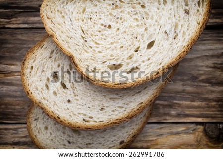 Slices of bread on a wooden background.