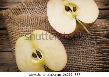 Apple on the wooden background.