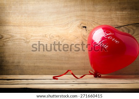Red heart-shaped balloon with the words I love you.