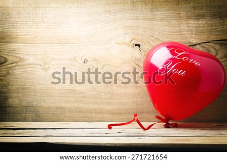 Red heart-shaped balloon with the words I love you.