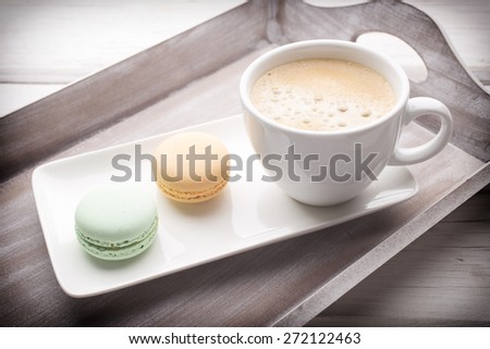 Macaroons and coffee on the table. Studio shoot.