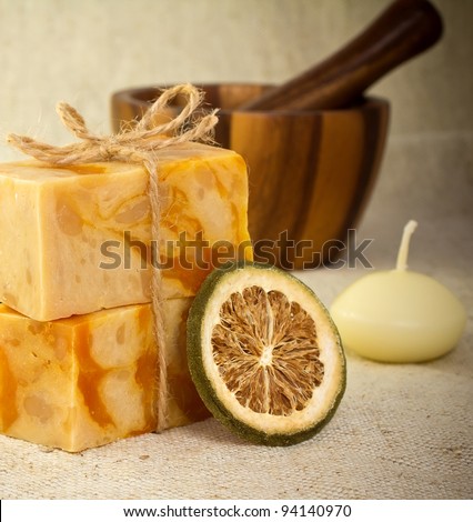 Natural soap with a dry lemon mortar with a pestle and a candle. Health spa for spa treatment.