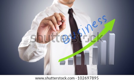 Business man drawing growth graph