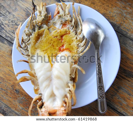 Giant lobster grilled compared size with spoon