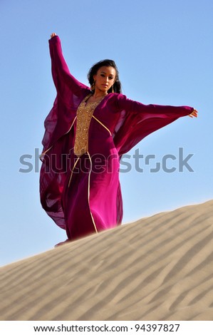 Beautiful brunette woman in desert. Dubai, United Arab Emirates.