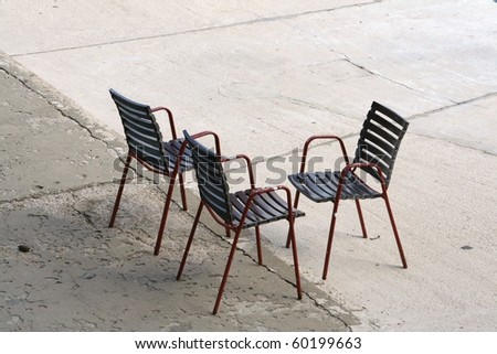 3 chairs on stone courtyard in Croatia